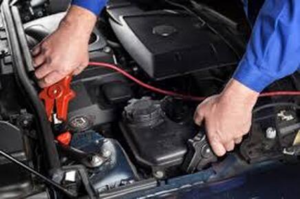 Roadside Assistance clamping jumper cables on frame and 