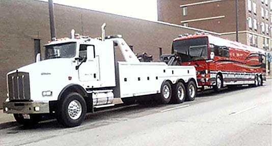 Heavy Duty Tow Truck hauling Tour Bus Recreational Vehicle